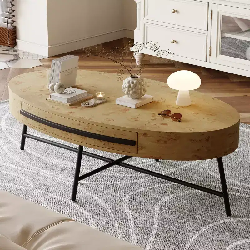 Oval coffee table with drawers, 47.2inches in diameter, featuring storage and cross-shaped metal legs; unique curved design, suitable for living room