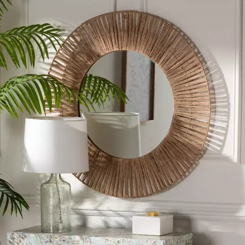 Modern Bohemian-style decorative hanging mirror featuring metal and natural brown seagrass