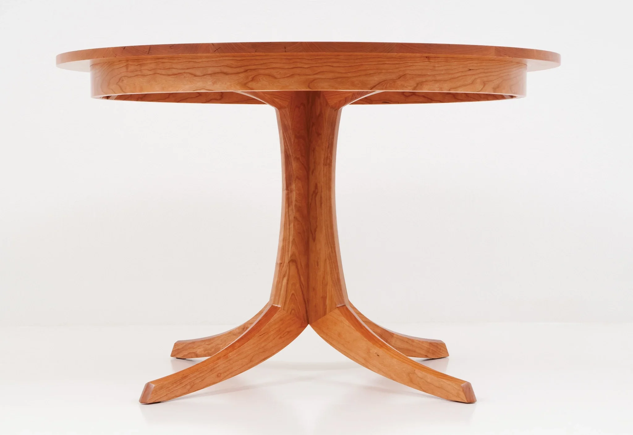 Table - Single Pedestal - The rests atop an innovative hardwood base that splays in four directions to provide strength