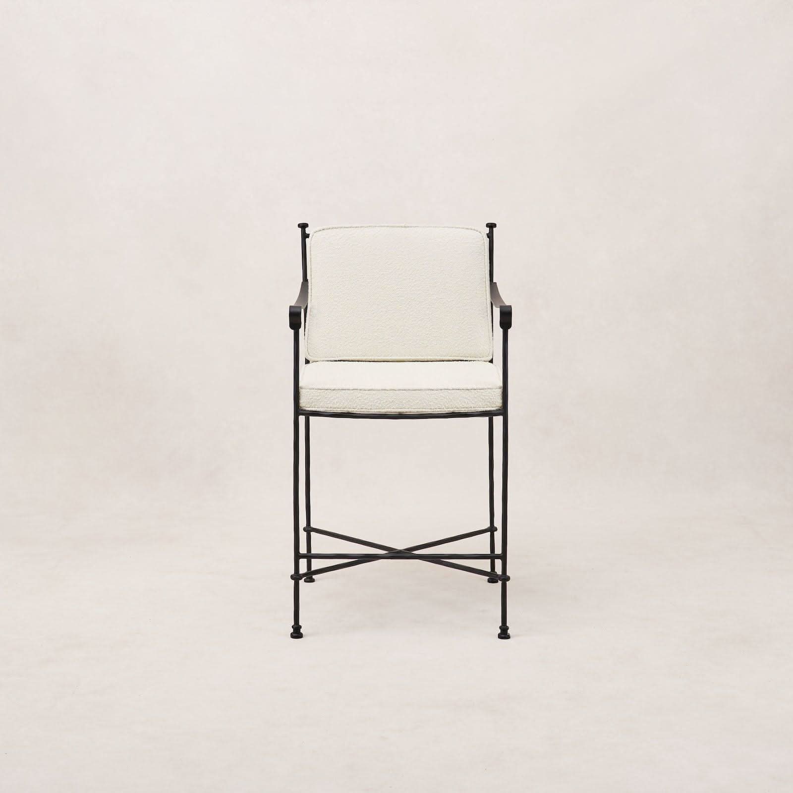 Outdoor Counter Stool - Boucle - Its delicate iron frame, finished in a durable matte-black powder coat, recalls the silhouettes of classic garden...