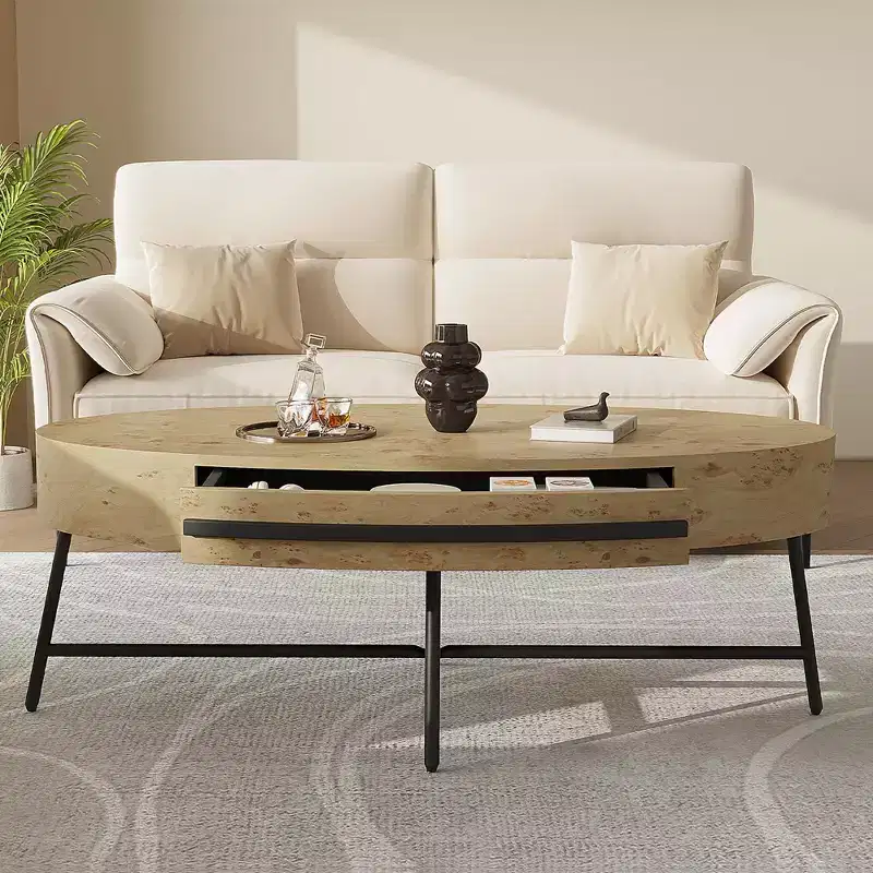 Oval coffee table with drawers, 47.2inches in diameter, featuring storage and cross-shaped metal legs; unique curved design, suitable for living room